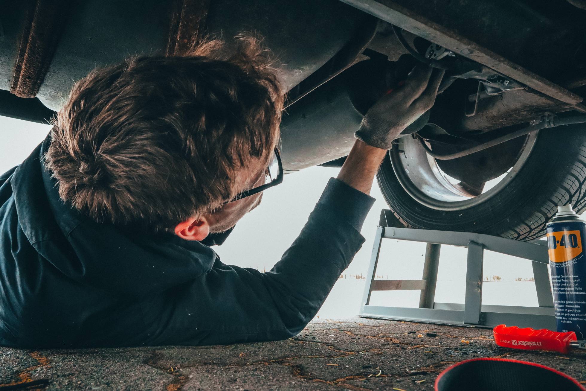 Mechanic Under Car doing MOT